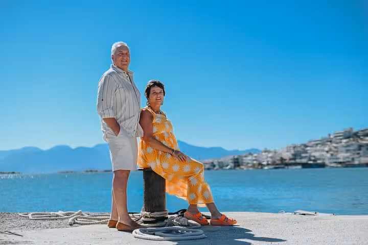 Couple enjoys a sunny day by the waterfront in Elounda, ideal for capturing memories with a private photoshoot.