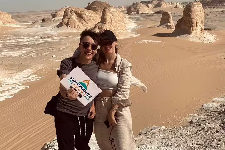 Couple at White Desert rock formations near Bahariya Oasis on a 3 days 2 nights desert camping tour