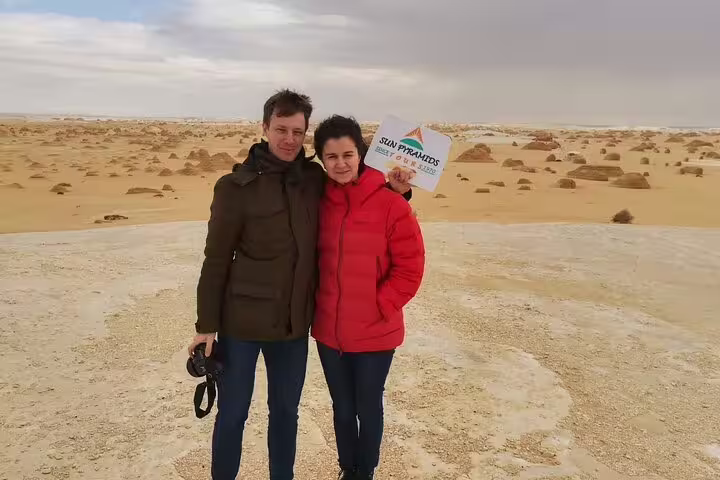 Couple at the White Desert chalk landscape on a 5-day Djara Cave, Black & White Desert adventure and camping trip