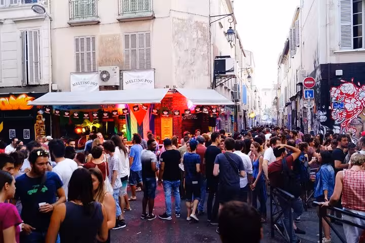 Bustling Cours Julien square in Marseille with bars and street art, evening crowd on Noailles tour