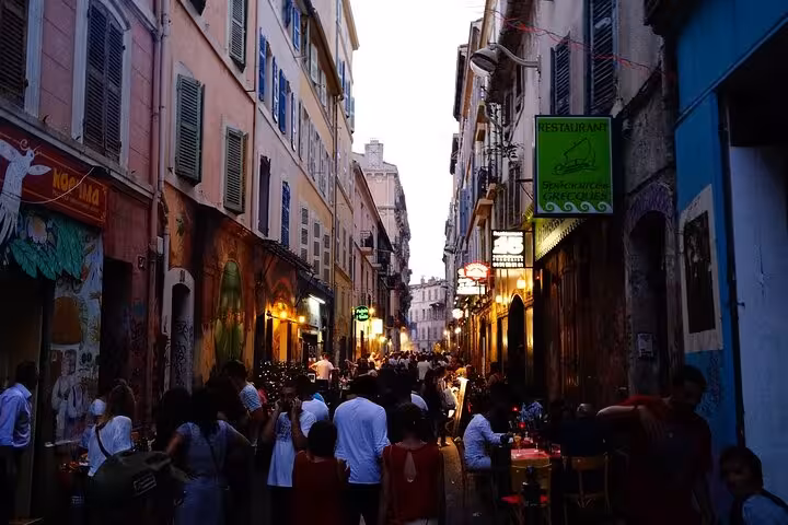 Evening crowd on Rue du Cours Julien, Marseille street art district near Noailles market on guided tour