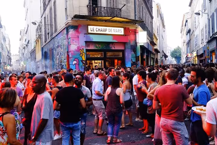 Lively Cours Julien square in Marseille with street art bars and crowds, walking tour near Noailles market