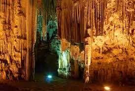 Illuminated stalactites inside a Cretan cave on a Crete history and culture day trip excursion