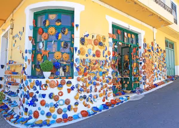 Colorful Cretan pottery shop facade with handmade ceramics, part of a Crete cultural day trip workshop