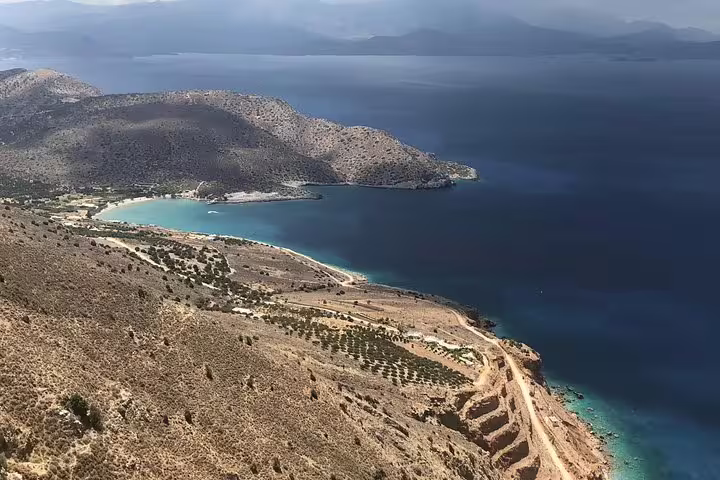 Stunning aerial view of Crete's north coast with azure waters, rolling hills, and olive groves near Azoria.