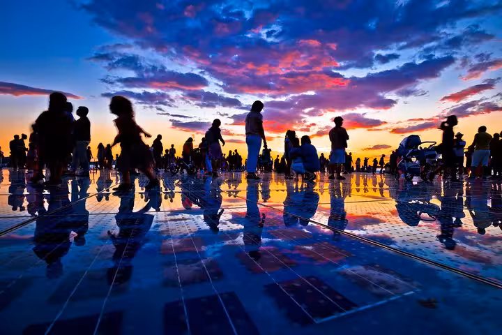 Sunset silhouettes on Zadar Sea Organ promenade, Adriatic evening experience on Croatia & Surroundings private tour