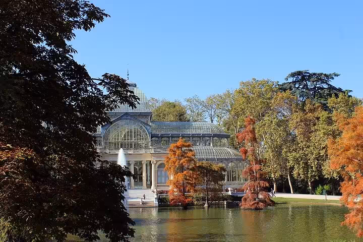 Scenic autumn view of the Crystal Palace in Retiro Park, Madrid, featured in the Granada, Toledo & Madrid tour.