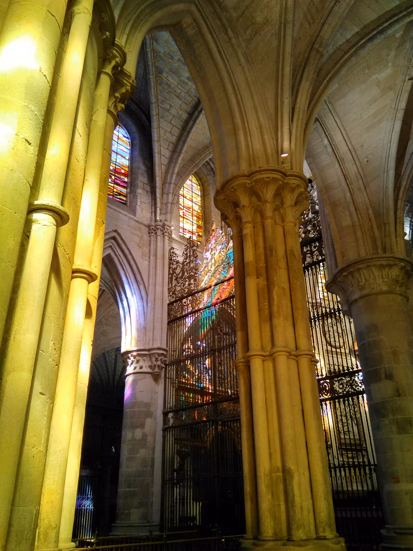 Gothic nave of Cuenca Cathedral on guided day tour from Madrid, soaring columns and vibrant stained glass