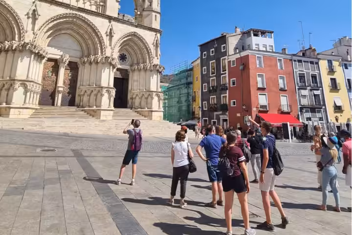 Tour group in Plaza Mayor admiring Cuenca Cathedral on a Cuenca and Enchanted City day trip from Madrid
