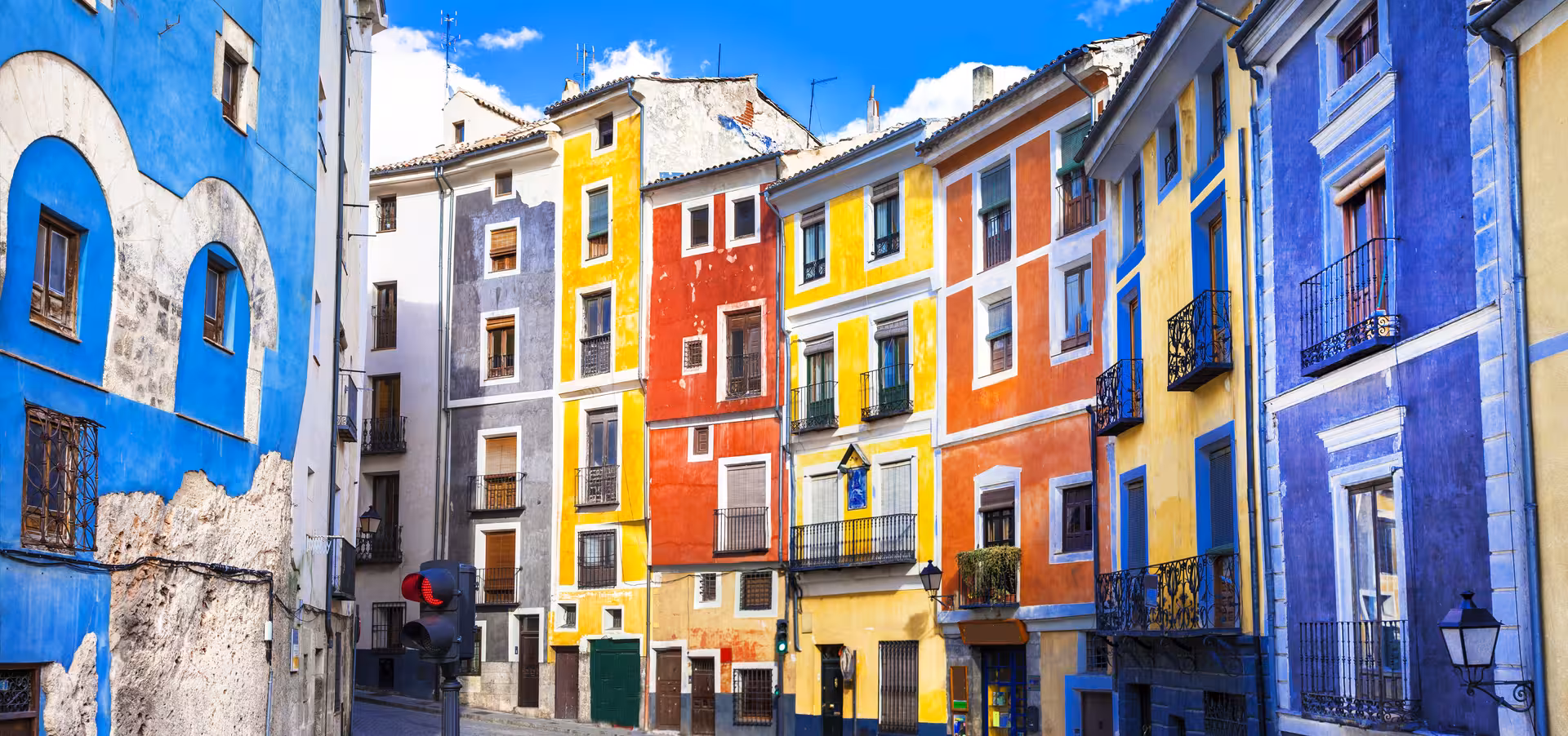 Colorful facades in Cuenca old town streets on excursion from Madrid, exploring historic center near Hanging Houses