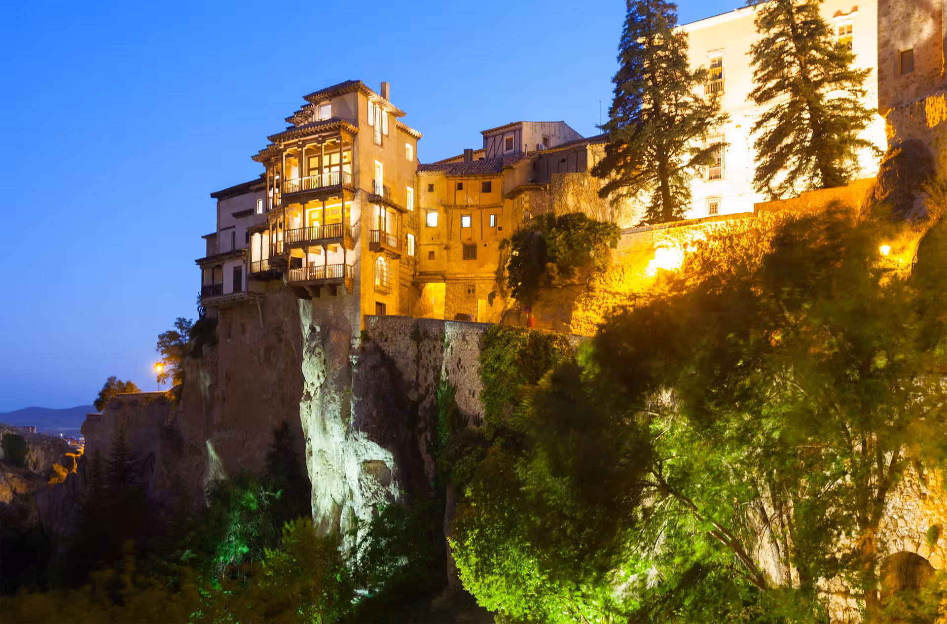 Cuenca Hanging Houses at dusk, iconic cliffside landmark visited on Madrid to Cuenca excursion with guided tour