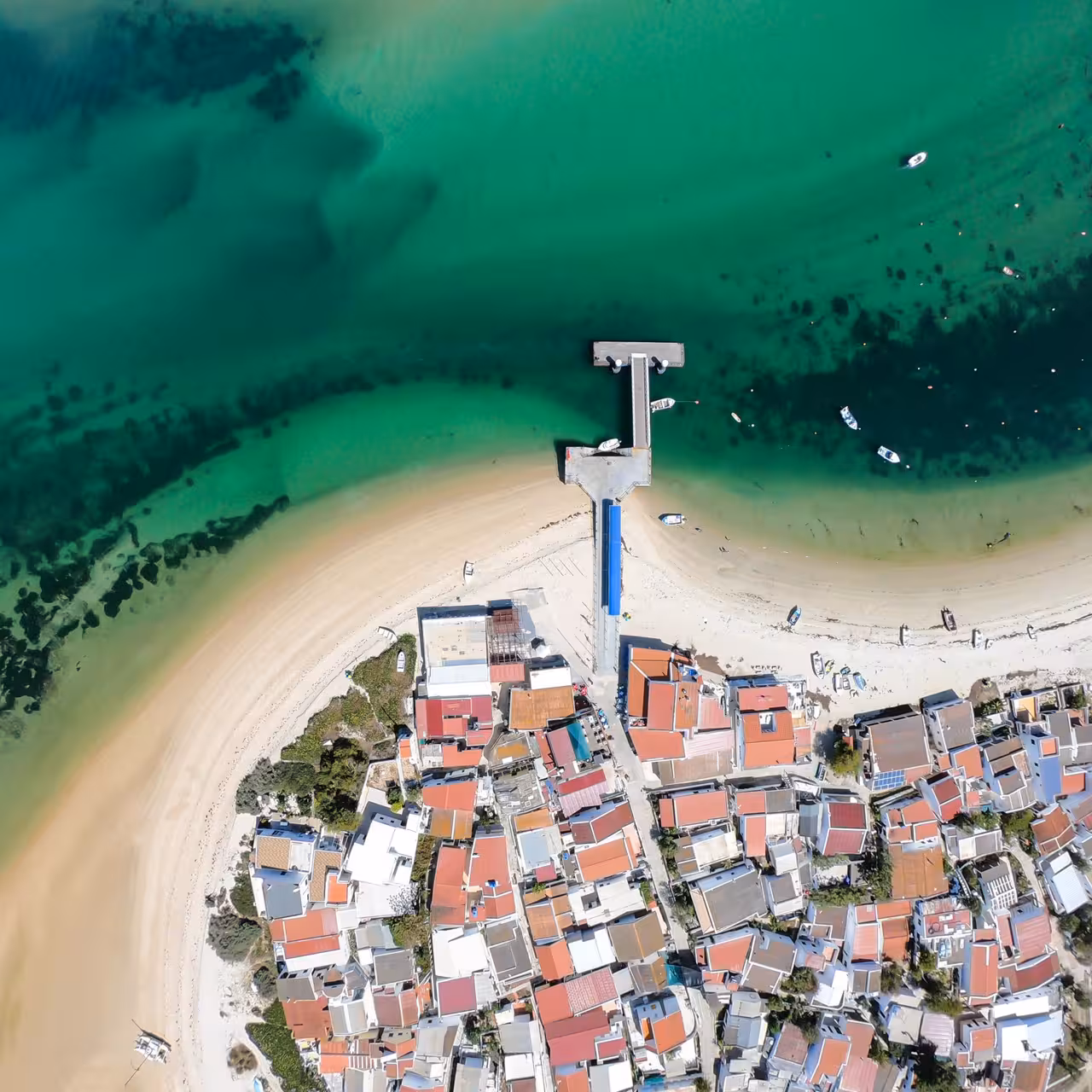 Aerial view of Culatra Island pier and sandy beach, Ria Formosa, on boat tour from Olhão in Algarve
