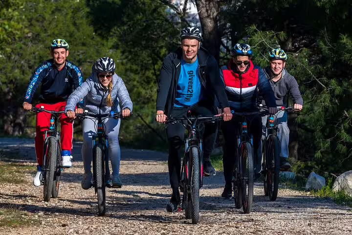 Cyclists riding a forest trail in Split on the Bike, Beer & Poljud Stadium Tour adventure