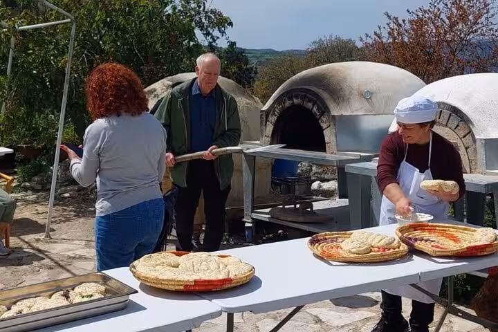 Traditional Cypriot bread baking workshop by stone oven, part of an authentic Cyprus wine and culture experience