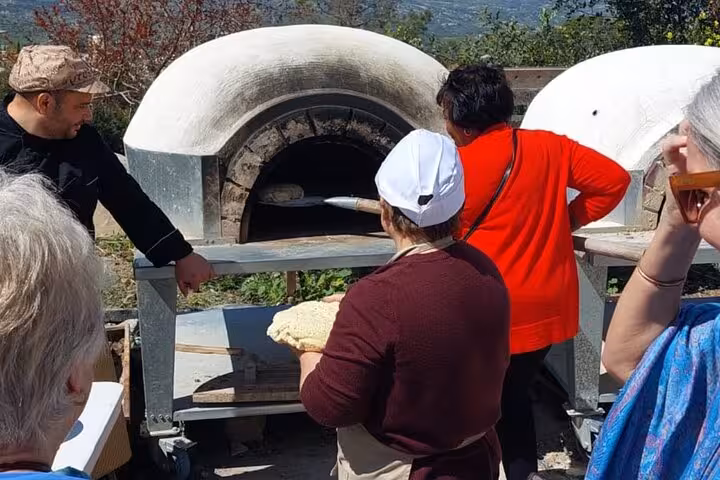 Visitors watch village oven baking during a hands-on Cypriot food workshop, an authentic cultural tour in Cyprus