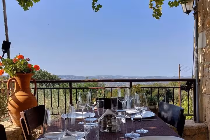 Wine glasses set on a Cyprus village terrace with mountain views, part of authentic Cypriot wine and culture tour