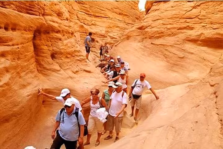 Group hiking through Canyon Salama on Dahab desert safari excursion from Sharm El Sheikh, Sinai sandstone gorge