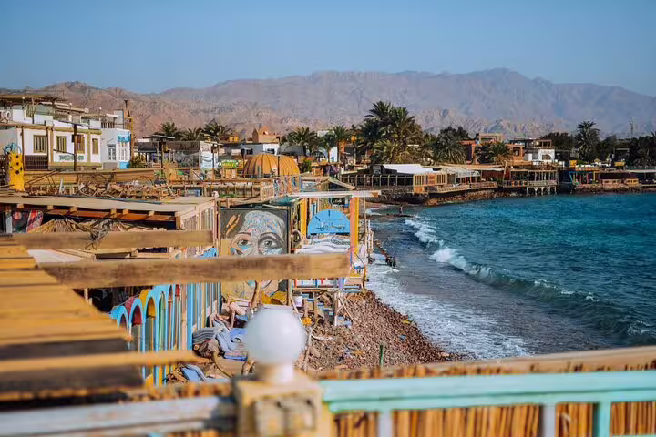 Dahab seafront promenade with colorful cafes and Red Sea views on Blue Hole day tour from Sharm El Sheikh