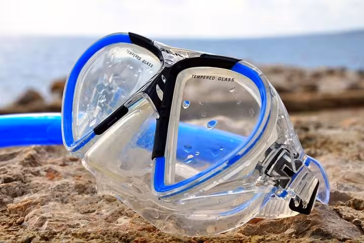Snorkeling mask on rocky shore, Red Sea Dahab snorkeling tour and Canyon Salama safari from Sharm El Sheikh