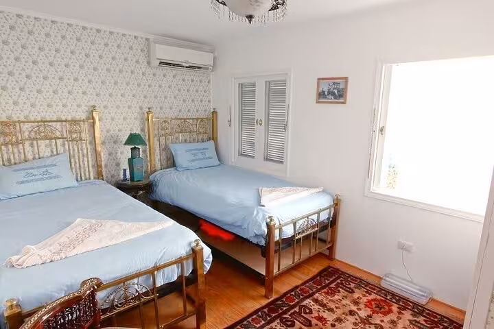 Twin-bed dahabiya cabin with air conditioning and bright window, 5-day Nile River cruise from Luxor to Aswan