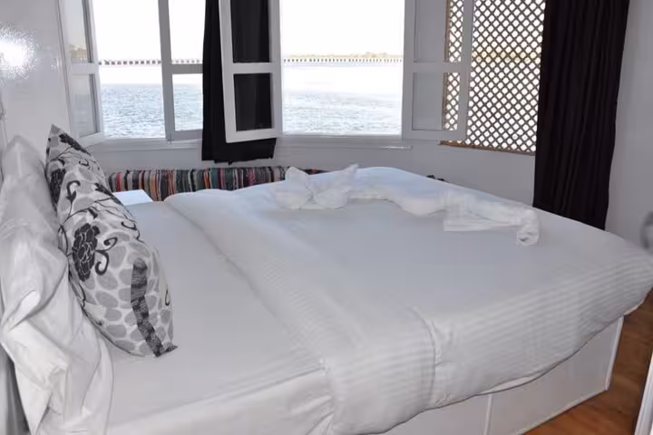 Dahabiya Nile cruise cabin double bed with river-view windows, 5 days 4 nights luxury Egypt sailing