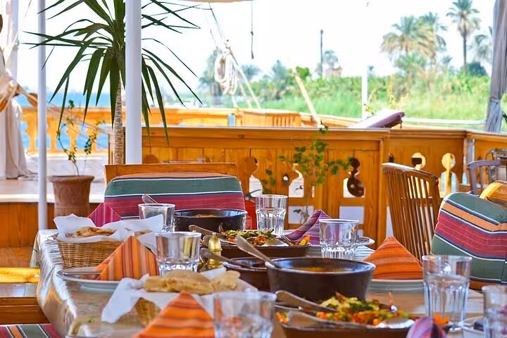 Outdoor dining table with Egyptian meals on Dahabiya Nile River cruise, 5 days Luxor to Aswan