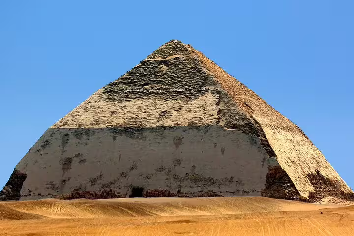 Wide desert view of Dahshur’s Bent Pyramid under clear blue sky, featured on Dahshur Pyramid and Memphis tour