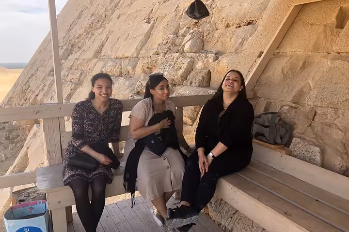 Travelers resting by the Dahshur Bent Pyramid on a private all-inclusive Cairo day tour to Dahshur, Memphis and Saqqara