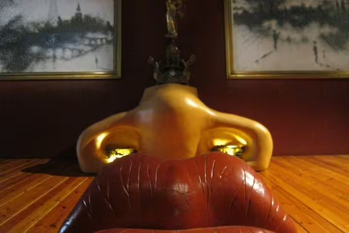 Close-up of Dalí's Mae West room exhibit featuring a sofa shaped like lips at the Dalí Museum, Costa Brava tour highlight.