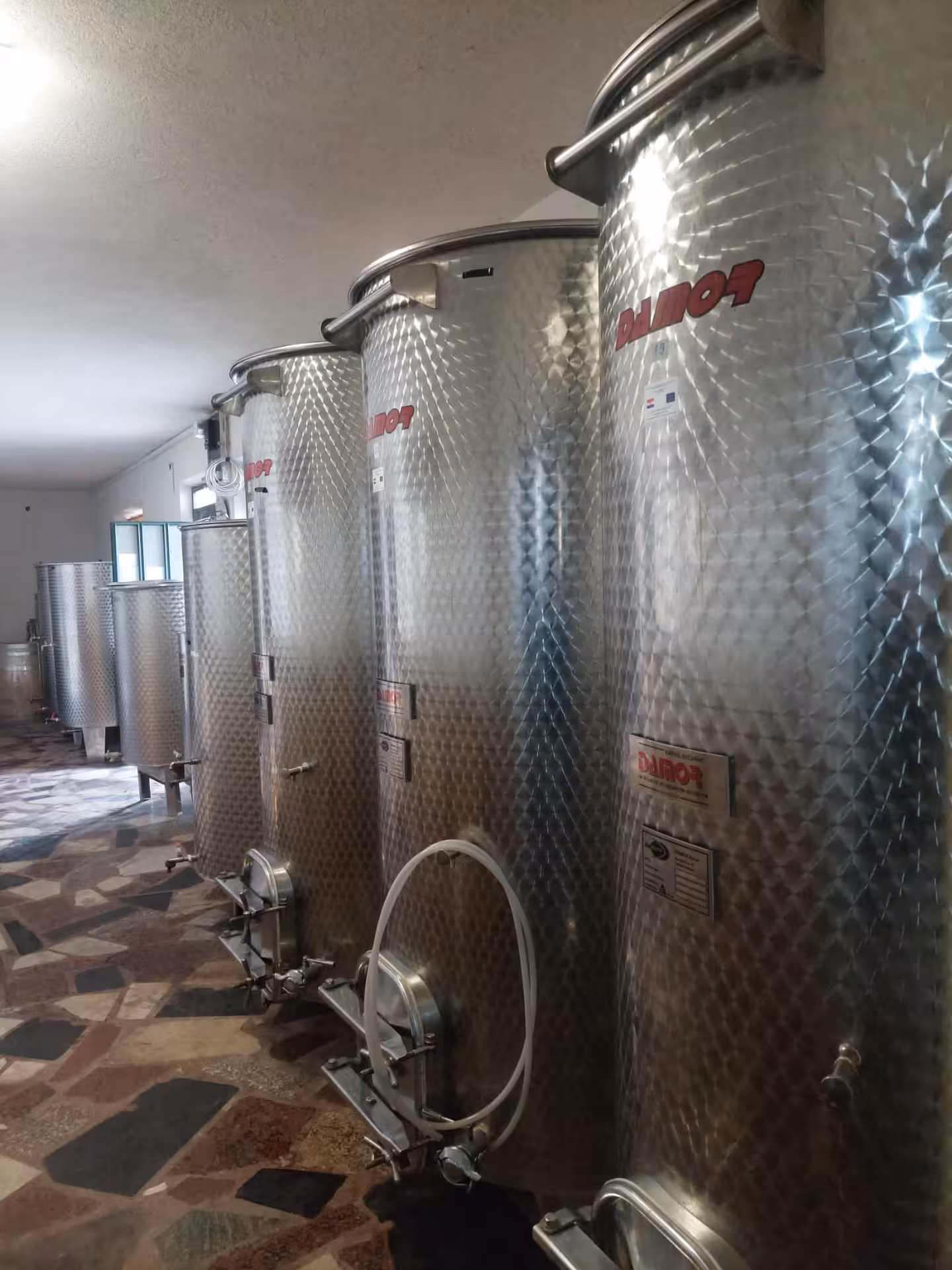 Stainless steel wine fermentation tanks at a Dalmatian winery on the Split to Imotski Lakes wine tour