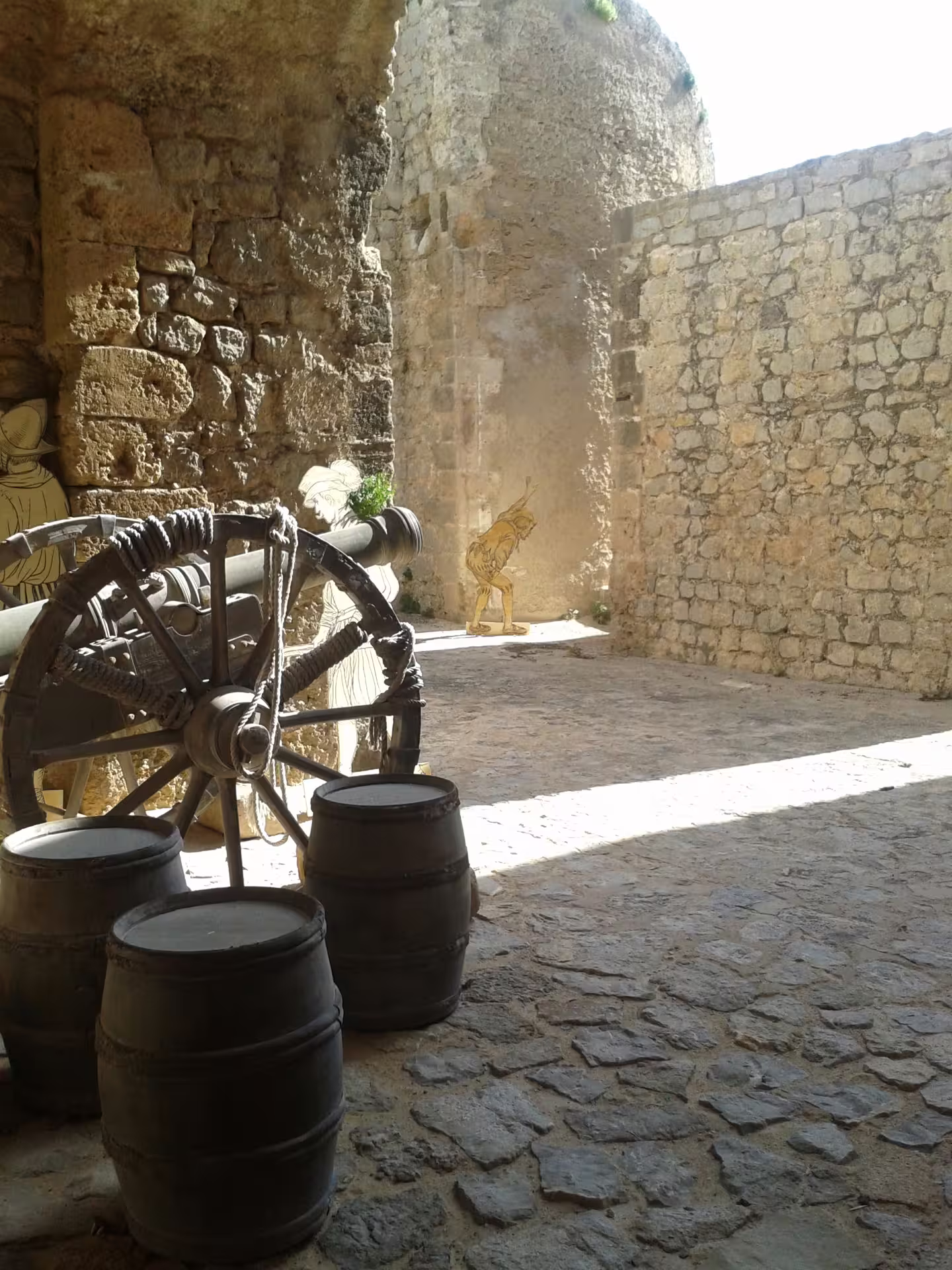 Dalt Vila courtyard with old cannon wheel and barrels, Ibiza Town, on Ibiza Night guided transfer with free time