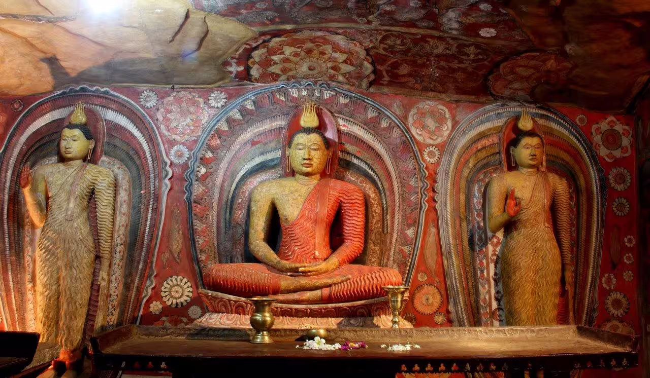 Intricate Buddha statues inside Dambulla Cave Temple showcasing rich cultural heritage on Kandy, Sigiriya & Dambulla tour.