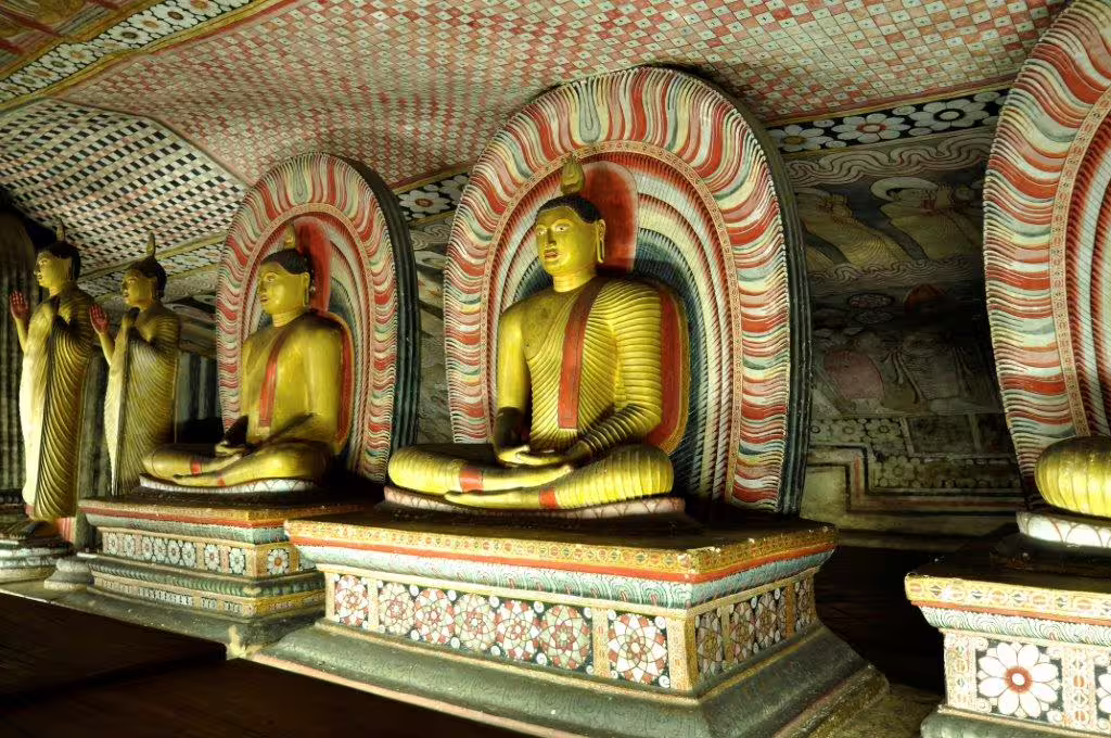 Explore the intricate Dambulla Cave Temple with golden Buddha statues and vibrant murals in Sri Lanka.