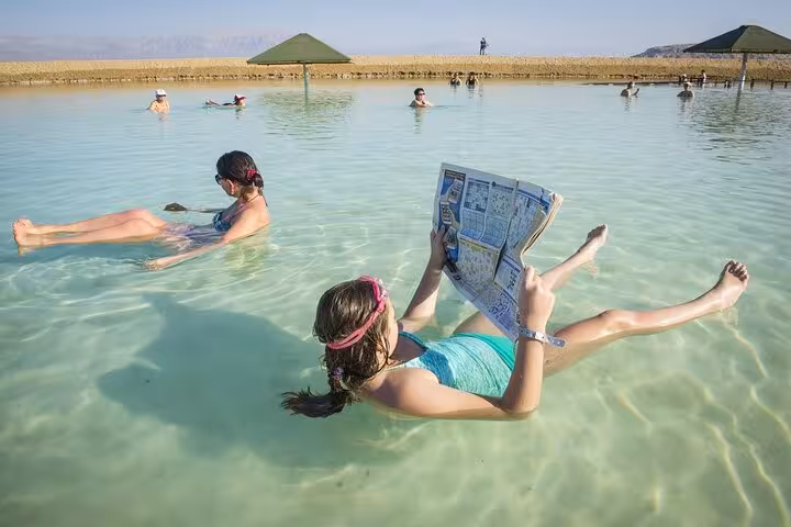 Travelers floating in the Dead Sea in Jordan, relaxing experience on 13-day Egypt Jordan Jerusalem tour
