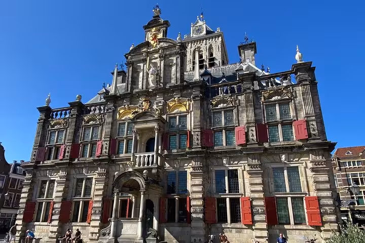 Historic Delft City Hall facade in Market Square, stop on private tour from Rotterdam to Kinderdijk and The Hague