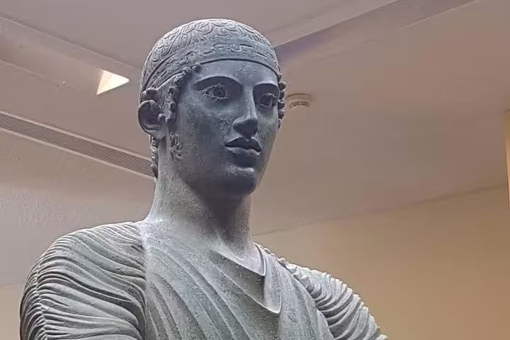 Ancient Greek bronze statue at Delphi Archaeological Museum on a private guided day tour from Athens