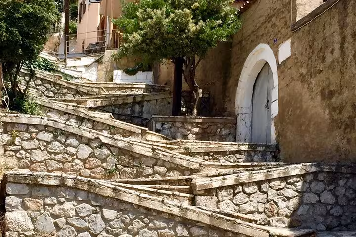 Charming stone stairway in Delphi, Greece, showcasing traditional architecture on a private full-day tour.