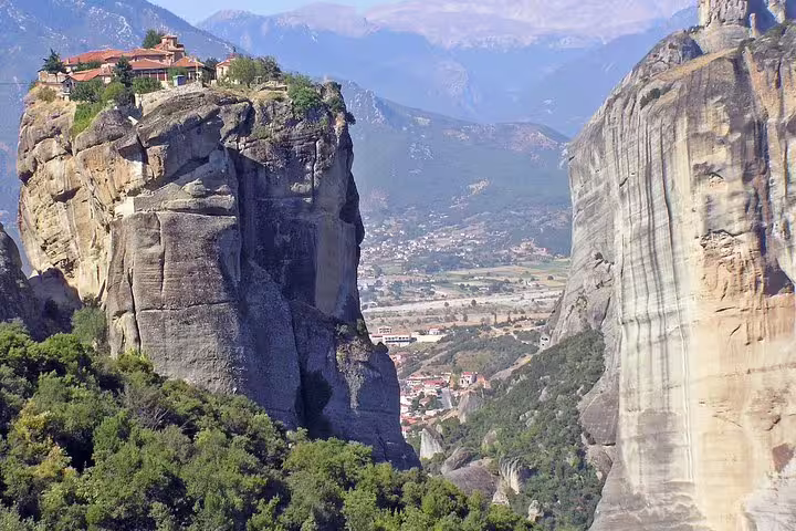 Panoramic Meteora landscape with monastery atop towering sandstone rock, seen on a 2-day private tour from Athens