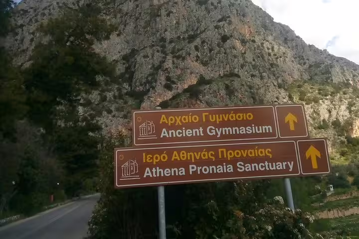 Road signs to Athena Pronaia Sanctuary and Ancient Gymnasium in Delphi on private day trip from Athens