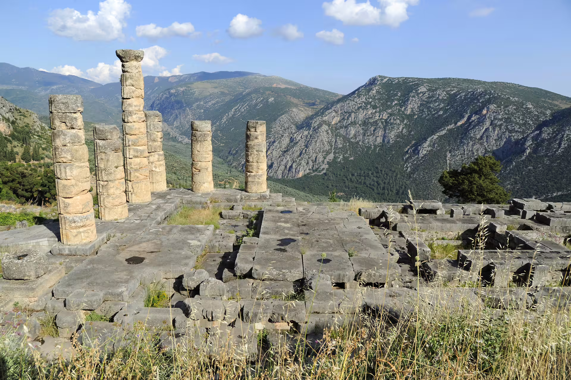 Ancient Delphi ruins and stone columns overlooking Mount Parnassus, highlight of 2-day private tour from Athens