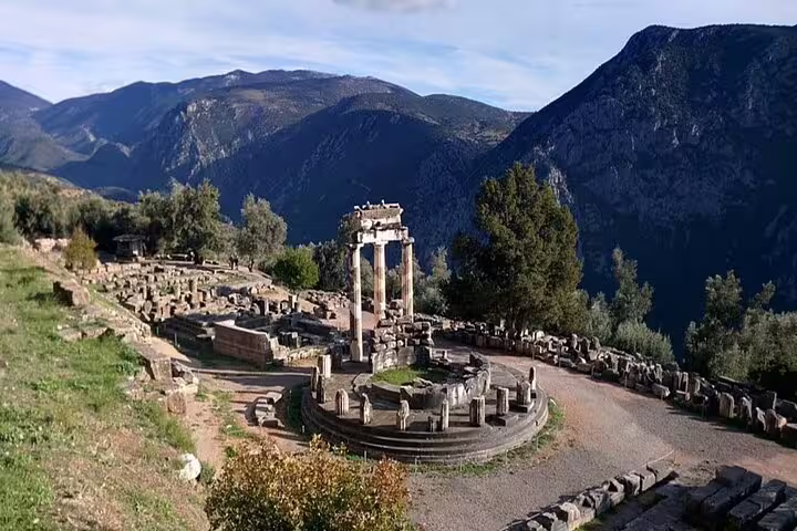 Delphi Tholos of Athena Pronaia with mountain views on a private full-day Delphi tour from Athens