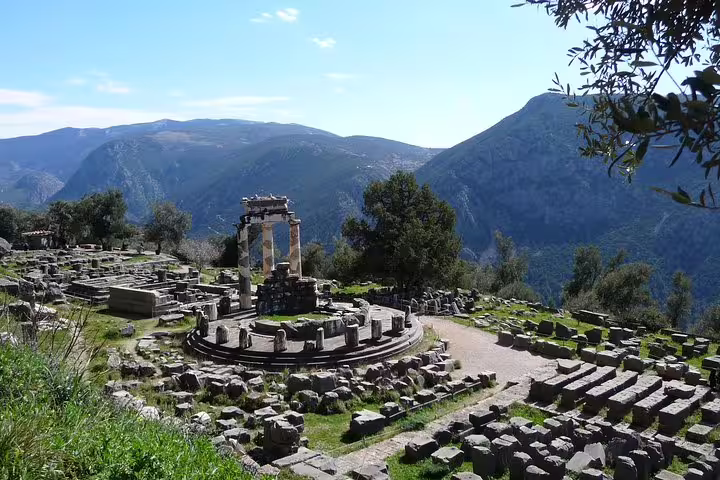 Delphi archaeological site with Tholos of Athena Pronaia ruins and Parnassus views on private day tour