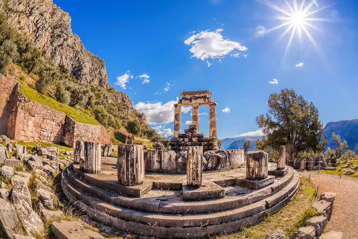 Tholos of Athena Pronaia at Delphi Archaeological Site under bright sun, highlight of full-day private tour