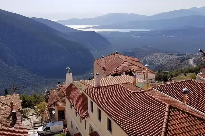 Delphi village rooftops with mountain and valley views, part of the 2-day private tour to Delphi and central Greece
