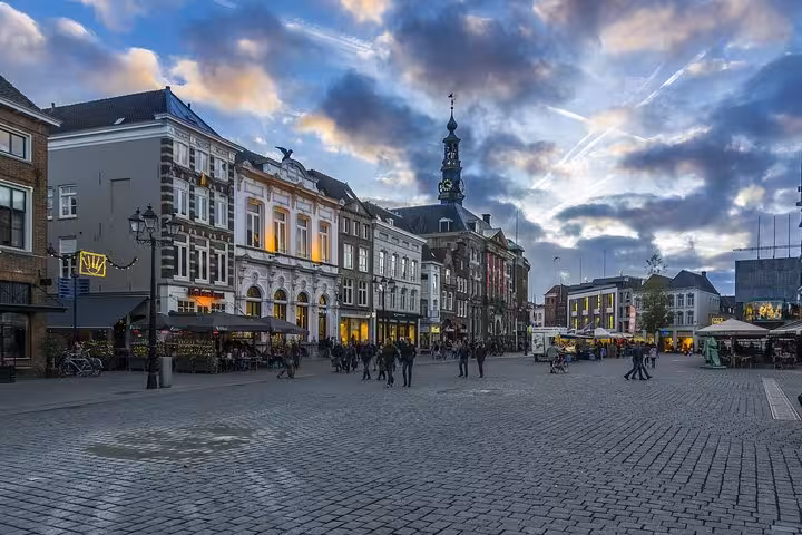 Den Bosch city center square at dusk, historic buildings and skyline, private transfer from Amsterdam or Schiphol