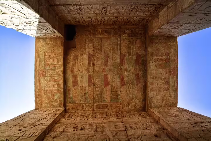 Painted ceiling reliefs and hieroglyphs at Medinet Habu temple, Luxor excursion to Dendera and West Bank