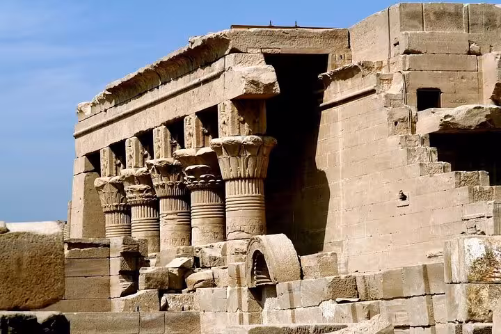 Side view of Dendera Temple ruins and Hathor columns, highlight of Dendera and Abydos tour from Hurghada