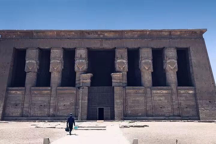 Front view of Dendera Temple's facade with massive Hathor columns, featured on a half-day private tour from Luxor.