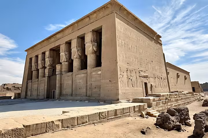 Exterior of Dendera Temple of Hathor with massive stone walls and columns, full-day tour from Hurghada