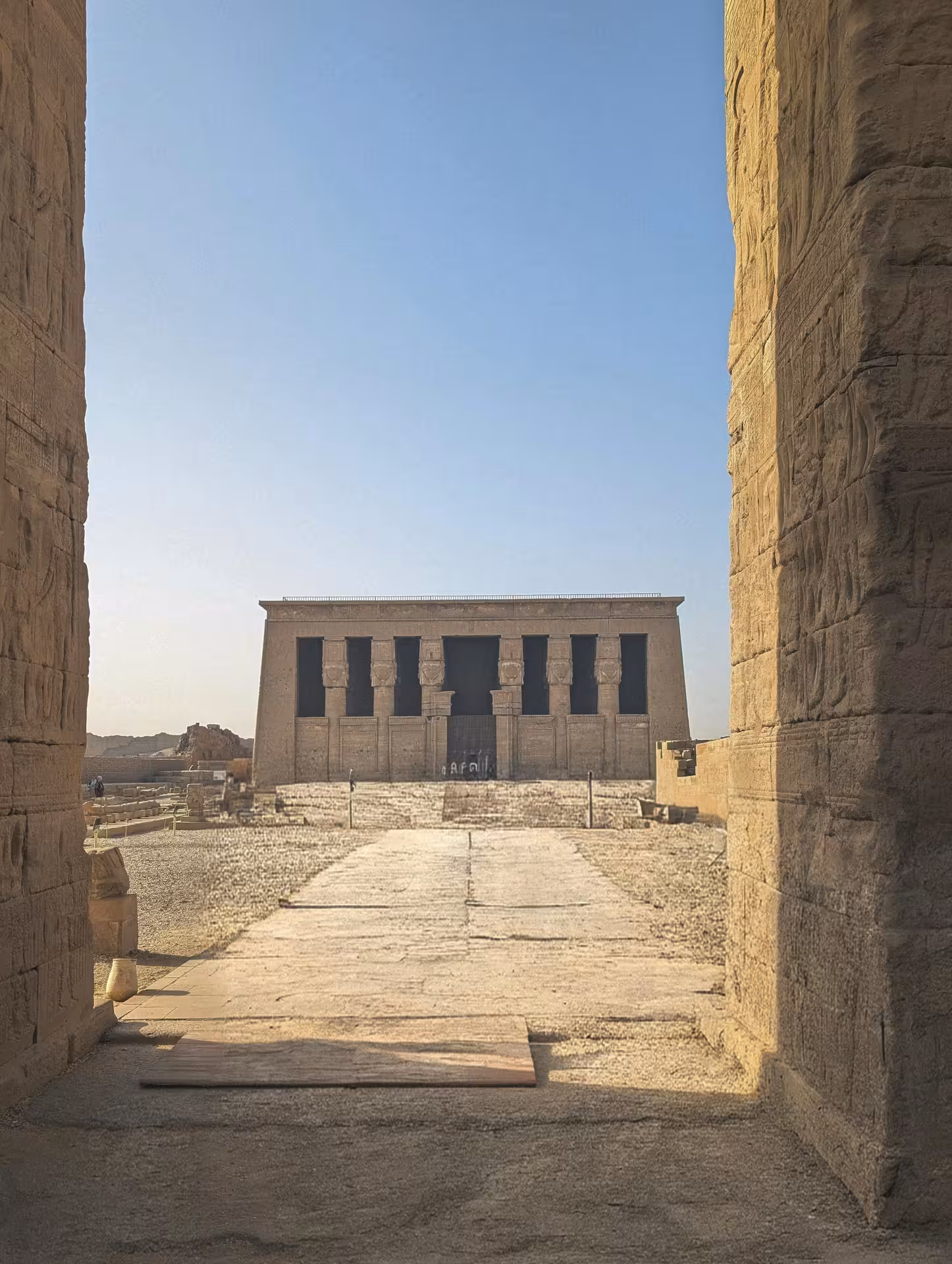 Stunning exterior view of Dendera Temple framed by stone gateway on a full-day tour from Safaga Egypt